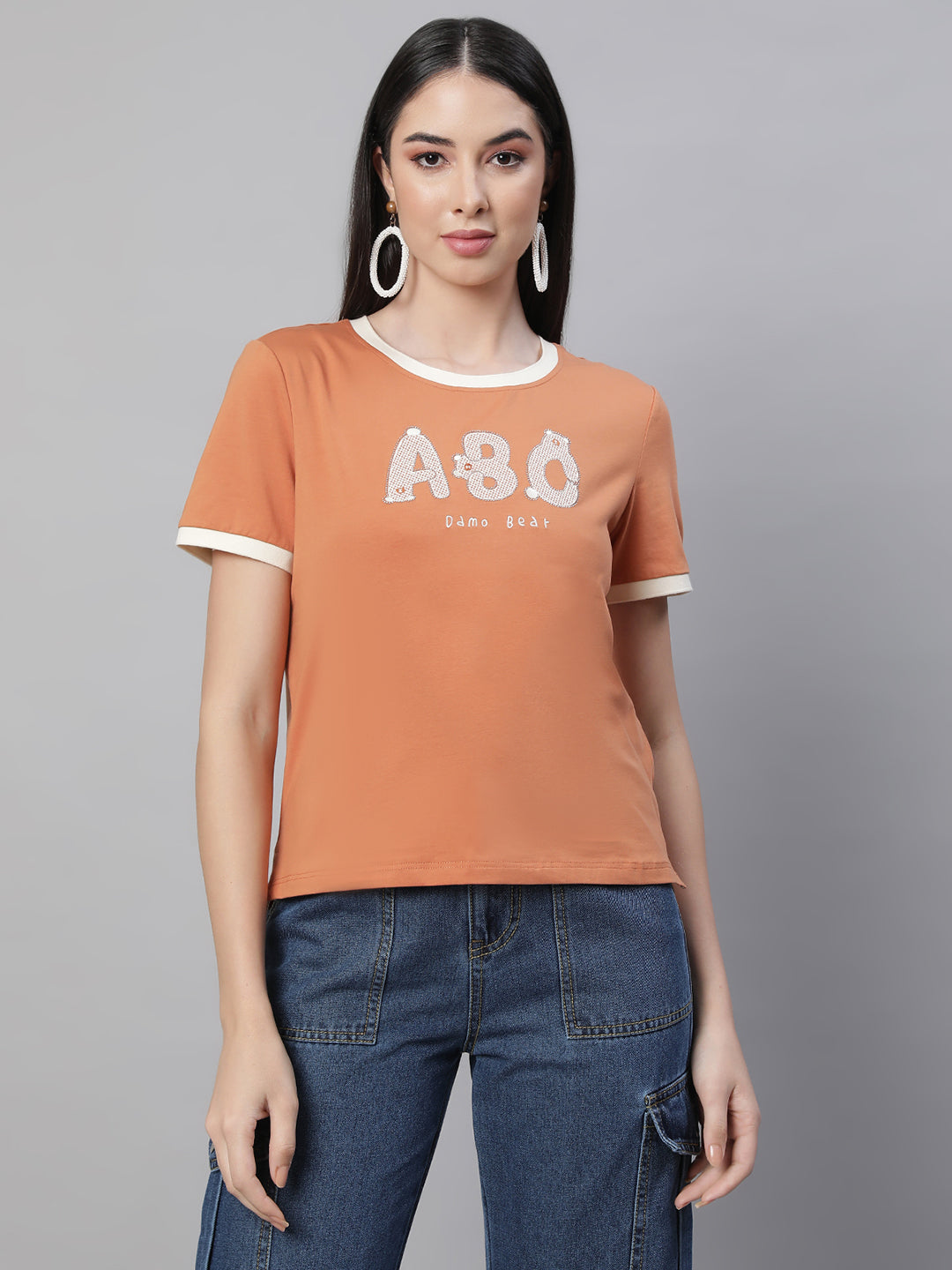 women orange round neck embellished top