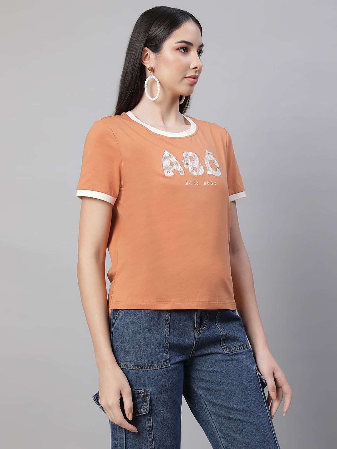 women orange round neck embellished top